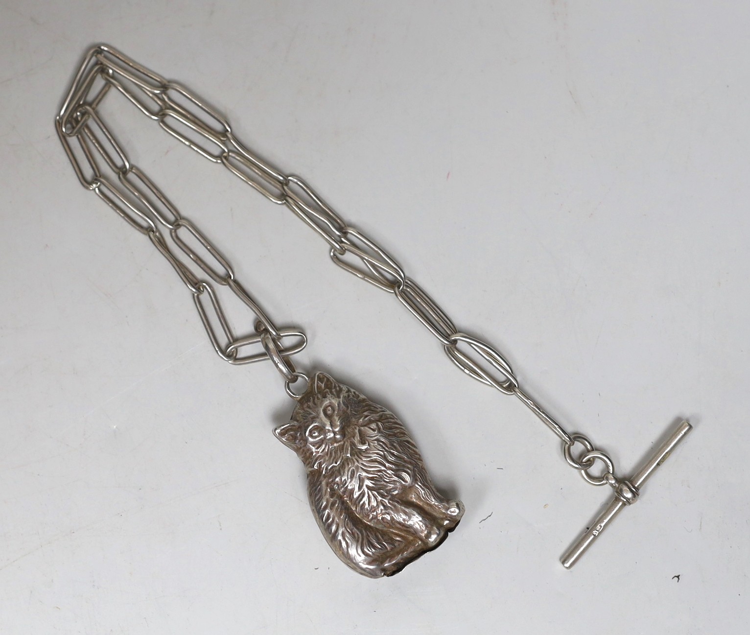 A modern silver rattle, modelled as a cat, 50mm, suspended from a 1920's silver albert.